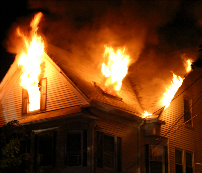 a house with fire blazing out of the windows